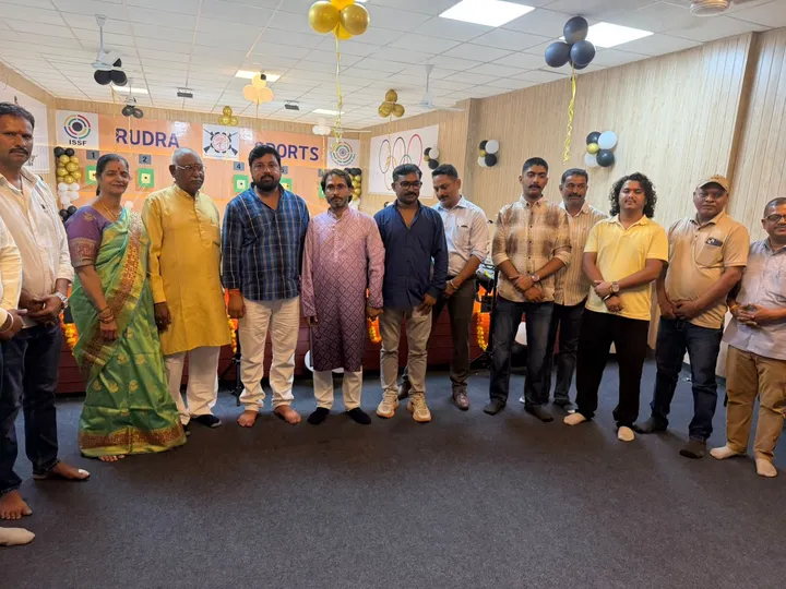 Guests and the academy team standing together in front of the Rudra Sports banner